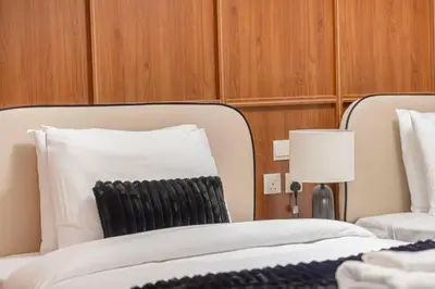 a bedroom with a white bed and a lamp at Modern 4BR Suite Overlooking Downtown in Dubai