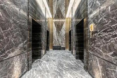 a hallway with black marble walls and a stone floor at Samaya Holiday Homes - Cloud Stylish Suites with Balcony in Dubai