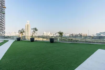 a field of green grass on the roof of a building at Samaya Holiday Homes - Cloud Stylish Suites with Balcony in Dubai