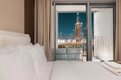 a bedroom with a bed with a view of a city at Luxury 4BR Burj Khalifa View Dubai Mall in Dubai