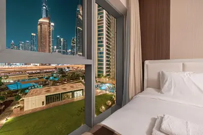 a bedroom with a view of a city skyline at Luxury 4BR Burj Khalifa View Dubai Mall in Dubai