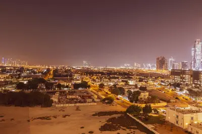 an aerial view of a city at night at Luxury 4BR Burj Khalifa View Dubai Mall in Dubai