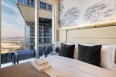 a bedroom with a bed with a large window at 2BR Luxury Hotel Amenities Dubai Mall Access in Dubai