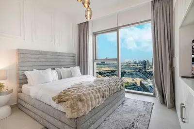 a bedroom with a large bed and a large window at 4Bedroom Luxury Stay in Downtown Views Dubai Mall in Dubai
