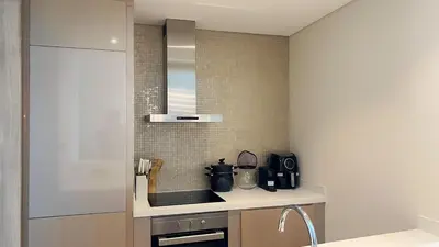 a kitchen with a sink and a counter top at Burj Khalifa View High Floor and Brand New in Dubai