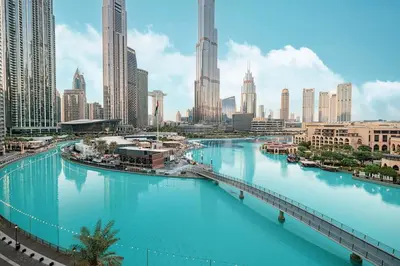 a view of a river in a city with tall buildings at Panoramic 4BR Burj Khalifa & Fountain View in Dubai