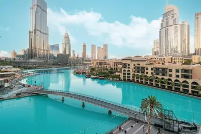 a view of a river in a city with buildings at Panoramic 4BR Burj Khalifa & Fountain View in Dubai