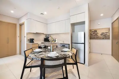 a dining room with a table and chairs in a kitchen at Cozy 1Bedroom Apartment Downtown Dubai Retreat in Dubai