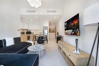 a living room with a couch and a table at Cozy 1Bedroom Apartment Downtown Dubai Retreat in Dubai