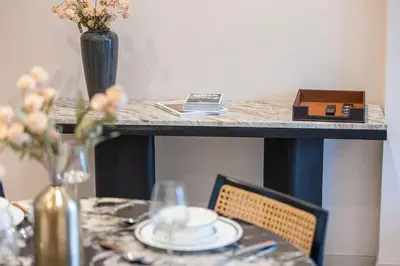 a table with a tableablishbestosbestosbestosbestosbestosbestosbestosbestosbestosbestos at Cozy 1Bedroom Apartment Downtown Dubai Retreat in Dubai