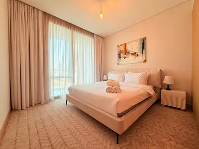 a bedroom with a large bed and a large window at Center to Burj Khalifa I Brand New I High End in Dubai