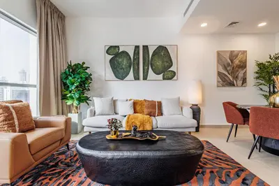 a living room with a couch and a table at Stunning Skyline Views and Prime Walkable Location in Dubai