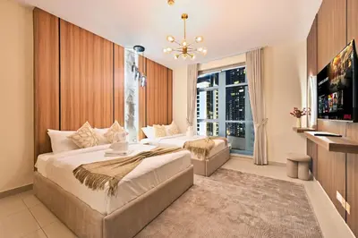 a bedroom with two beds and a large window at Luxury 2BR Downtown Walk to Dubai Mall Burj Khalifa in Dubai