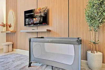 a television in a living room with a tv at Luxury 2BR Downtown Walk to Dubai Mall Burj Khalifa in Dubai