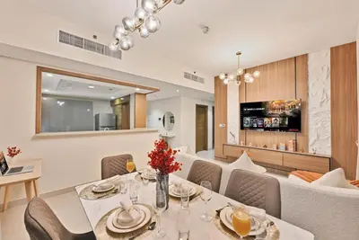 a dining room with a table and chairs at Luxury 2BR Downtown Walk to Dubai Mall Burj Khalifa in Dubai