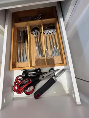 a drawer filled with scissors and other kitchen utensils at Modern & Cozy 1BR Apartment with Full Comfort in Dubai
