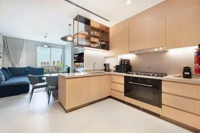 a kitchen and a living room with a couch at 4BR Luxury Hotel Amenities Dubai Mall Access in Dubai