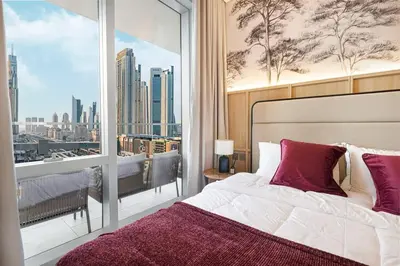 a bedroom with a bed and a large window at 4BR Luxury Hotel Amenities Dubai Mall Access in Dubai