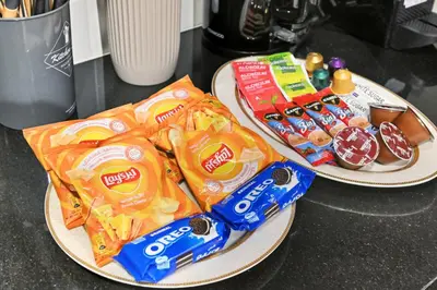 two plates with snacks on them on a counter at 22nd Floor Burj Khalifa View 5 Min Walk Dubai Mall in Dubai