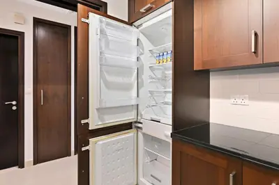 an empty refrigerator with its door open in a kitchen at 22nd Floor Burj Khalifa View 5 Min Walk Dubai Mall in Dubai