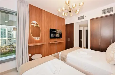 a hotel room with two beds and a tv at 22nd Floor Burj Khalifa View 5 Min Walk Dubai Mall in Dubai