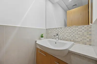 a bathroom with a white sink and a mirror at Luxury 1BHK Burj Khalifa View Short Walk Dubai Mall in Dubai