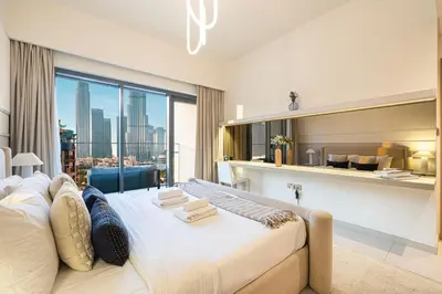 a bedroom with a large bed and a large window at Designer 2BR, Burj Khalifa View & Dubai Mall 2 minutes walk in Dubai