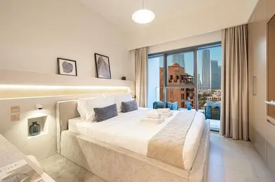 a bedroom with a large bed and a large window at Designer 2BR, Burj Khalifa View & Dubai Mall 2 minutes walk in Dubai