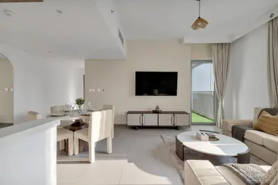 a living room with a couch and a table at Stylish 2 bedroom with Burj Khalifa View, connected to Dubai Mall in Dubai