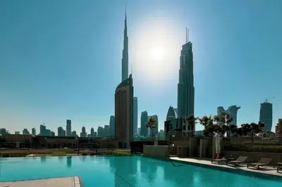 a swimming pool with a city skyline in the background at Stylish 2 bedroom with Burj Khalifa View, connected to Dubai Mall in Dubai