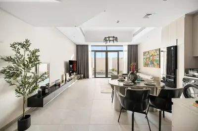 a kitchen and dining room with a table and chairs at 2.5BR Villa | PS5 & Private Pool | Near Dubai Mall in Dubai