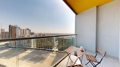 a balcony with two chairs and a table on a building at Vacationer l Contemporary 1 Bedroom l Free Pool, Gym Access in Dubai