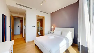a bedroom with a large white bed in a room at Vacationer l Contemporary 1 Bedroom l Free Pool, Gym Access in Dubai