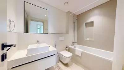 a bathroom with a sink and a toilet and a mirror at Vacationer l Stunning 2 Bed l Marina Skyline l Beach Access in Dubai