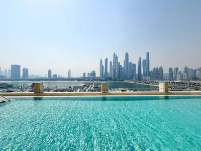 a swimming pool with a city skyline in the background at Vacationer l Stunning 2 Bed l Marina Skyline l Beach Access in Dubai