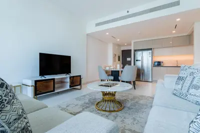 a living room with a couch and a table at Vacationer l Stunning 2 Bed l Marina Skyline l Beach Access in Dubai