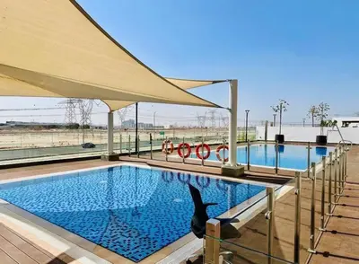 a large swimming pool with a black dolphin sitting next to it at Luxurious One Bedroom Apartment - Azizi Riviera in Dubai