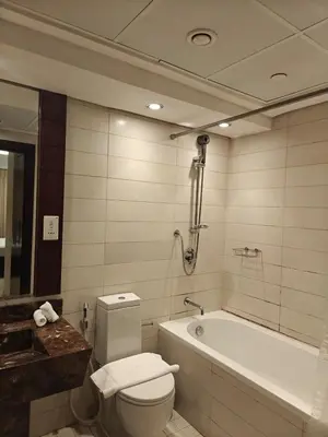 a bathroom with a toilet and a bath tub at Clear Burj Khalifa View Large Downtown Studio in Dubai