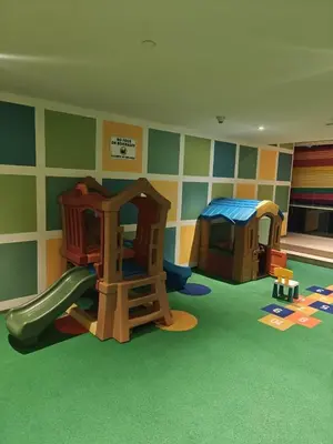 a childrens play room with two play equipment at Clear Burj Khalifa View Large Downtown Studio in Dubai