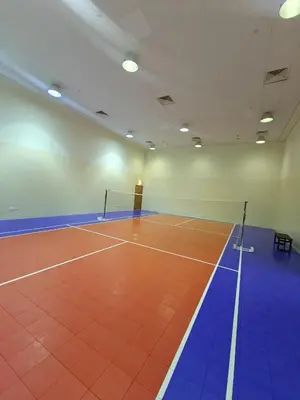 a gymnasium with a tennis court in a room at Clear Burj Khalifa View Large Downtown Studio in Dubai