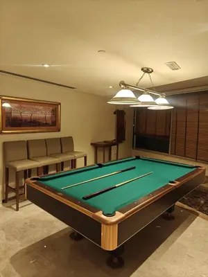 a pool table in a living room with ahibition at Clear Burj Khalifa View Large Downtown Studio in Dubai
