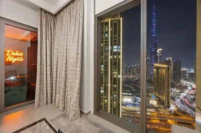 a room with a large window with a view of a city at Hermès 2BR Burj Khalifa & Fountain View With Direct Dubai Mall Access in Dubai