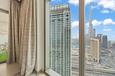 a room with a window with a view of a city at Hermès 2BR Burj Khalifa & Fountain View With Direct Dubai Mall Access in Dubai