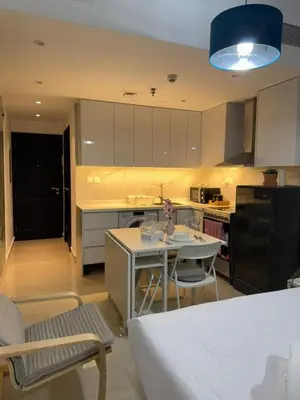 a kitchen with a table and a blue light at Cozy Studio in the Heart of Dubai Marina in Dubai
