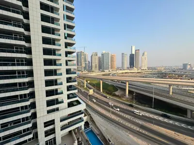 a view of a city with a highway and buildings at Cozy Studio in the Heart of Dubai Marina in Dubai
