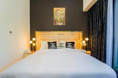 a bedroom with a large white bed and a window at NYC x DXB with Full Burj Khalifa View in Downtown Dubai in Dubai