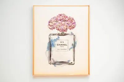 a framed picture of a perfume bottle filled with flowers at NYC x DXB with Full Burj Khalifa View in Downtown Dubai in Dubai