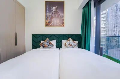 a bedroom with two white beds and a window at NYC x DXB with Full Burj Khalifa View in Downtown Dubai in Dubai