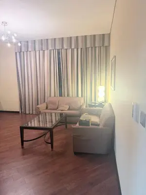 a living room with a couch and a coffee table at Diligence Barsha Apartment in Dubai