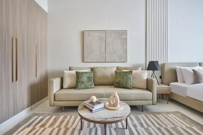 a living room with a couch and a table at Pool View Studio Near to circle mall - Icon casa Living in Dubai